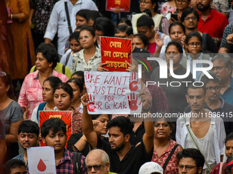 Students and citizens hold various posters during a rally in Kolkata, India, on September 1, 2024, demanding punishment for the accused invo...