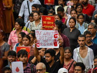 Students and citizens hold various posters during a rally in Kolkata, India, on September 1, 2024, demanding punishment for the accused invo...