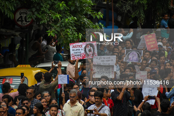 Students and citizens hold various posters during a rally in Kolkata, India, on September 1, 2024, demanding punishment for the accused invo...