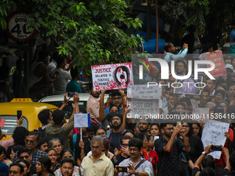 Students and citizens hold various posters during a rally in Kolkata, India, on September 1, 2024, demanding punishment for the accused invo...