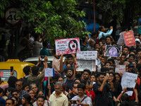 Students and citizens hold various posters during a rally in Kolkata, India, on September 1, 2024, demanding punishment for the accused invo...