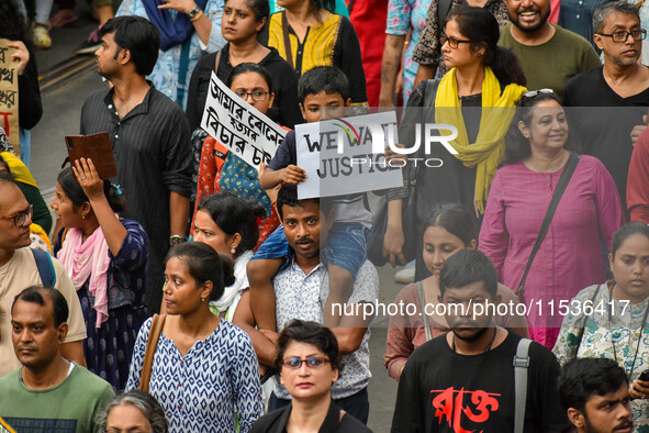 Students and citizens hold various posters during a rally in Kolkata, India, on September 1, 2024, demanding punishment for the accused invo...