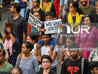 Students and citizens hold various posters during a rally in Kolkata, India, on September 1, 2024, demanding punishment for the accused invo...