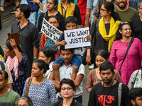 Students and citizens hold various posters during a rally in Kolkata, India, on September 1, 2024, demanding punishment for the accused invo...