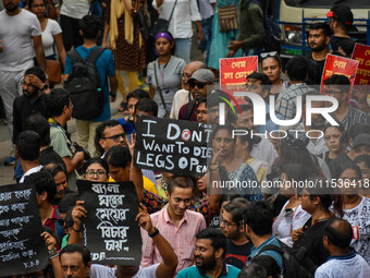 Students and citizens hold various posters during a rally in Kolkata, India, on September 1, 2024, demanding punishment for the accused invo...