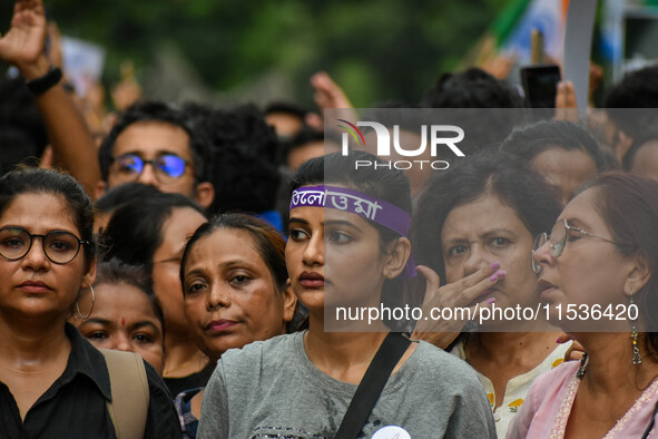 Students and citizens hold various posters during a rally in Kolkata, India, on September 1, 2024, demanding punishment for the accused invo...