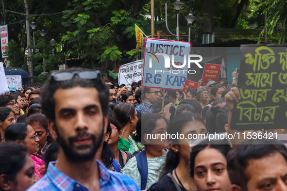 Students and citizens hold various posters during a rally in Kolkata, India, on September 1, 2024, demanding punishment for the accused invo...