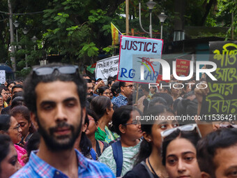 Students and citizens hold various posters during a rally in Kolkata, India, on September 1, 2024, demanding punishment for the accused invo...