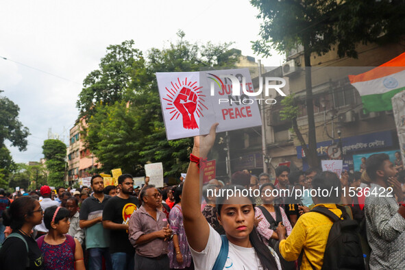 Students and citizens hold various posters during a rally in Kolkata, India, on September 1, 2024, demanding punishment for the accused invo...