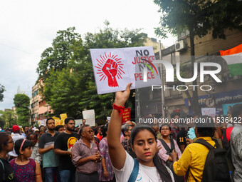 Students and citizens hold various posters during a rally in Kolkata, India, on September 1, 2024, demanding punishment for the accused invo...