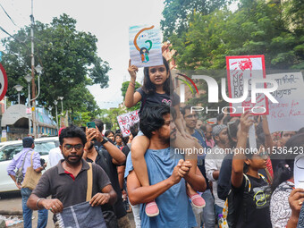 Students and citizens hold various posters during a rally in Kolkata, India, on September 1, 2024, demanding punishment for the accused invo...