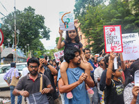 Students and citizens hold various posters during a rally in Kolkata, India, on September 1, 2024, demanding punishment for the accused invo...