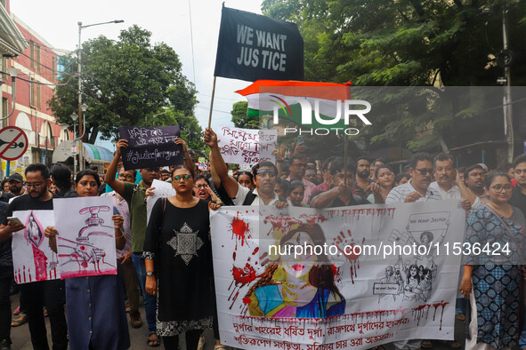 Students and citizens hold various posters during a rally in Kolkata, India, on September 1, 2024, demanding punishment for the accused invo...