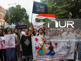 Students and citizens hold various posters during a rally in Kolkata, India, on September 1, 2024, demanding punishment for the accused invo...