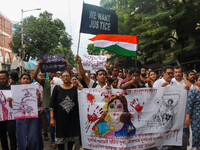 Students and citizens hold various posters during a rally in Kolkata, India, on September 1, 2024, demanding punishment for the accused invo...