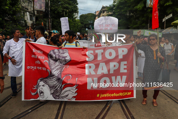 Students and citizens hold various posters during a rally in Kolkata, India, on September 1, 2024, demanding punishment for the accused invo...