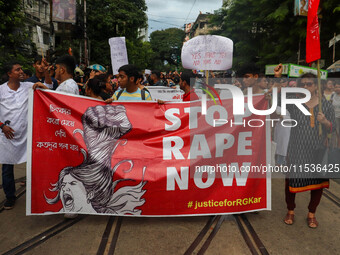 Students and citizens hold various posters during a rally in Kolkata, India, on September 1, 2024, demanding punishment for the accused invo...