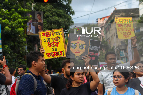 Students and citizens hold various posters during a rally in Kolkata, India, on September 1, 2024, demanding punishment for the accused invo...