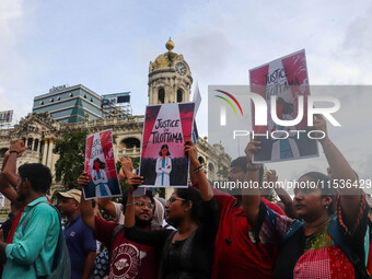 Students and citizens hold various posters during a rally in Kolkata, India, on September 1, 2024, demanding punishment for the accused invo...