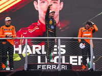 Charles Leclerc of Monaco drives the (16) Scuderia Ferrari SF-24 Ferrari, Oscar Piastri of Australia drives the (81) McLaren F1 Team MCL38 M...