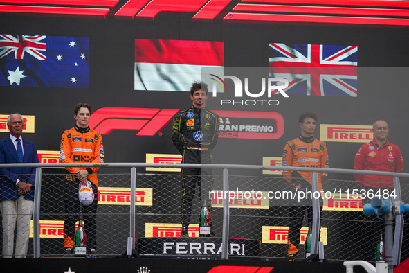 Charles Leclerc of Monaco drives the (16) Scuderia Ferrari SF-24 Ferrari, Oscar Piastri of Australia drives the (81) McLaren F1 Team MCL38 M...