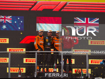 Charles Leclerc of Monaco drives the (16) Scuderia Ferrari SF-24 Ferrari, Oscar Piastri of Australia drives the (81) McLaren F1 Team MCL38 M...