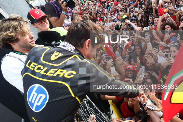 Charles Leclerc of Ferrari celebrates with fans after the Formula 1 Italian Grand Prix at Autodromo Nazionale di Monza in Monza, Italy on Se...