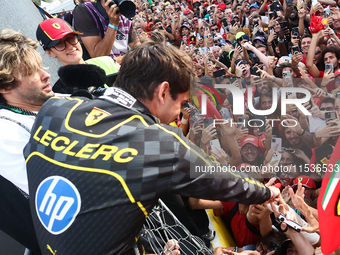 Charles Leclerc of Ferrari celebrates with fans after the Formula 1 Italian Grand Prix at Autodromo Nazionale di Monza in Monza, Italy on Se...