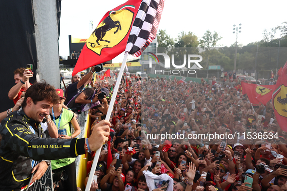 Charles Leclerc of Ferrari celebrates with fans after the Formula 1 Italian Grand Prix at Autodromo Nazionale di Monza in Monza, Italy on Se...