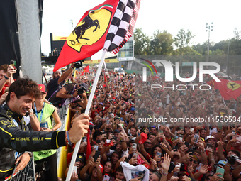 Charles Leclerc of Ferrari celebrates with fans after the Formula 1 Italian Grand Prix at Autodromo Nazionale di Monza in Monza, Italy on Se...