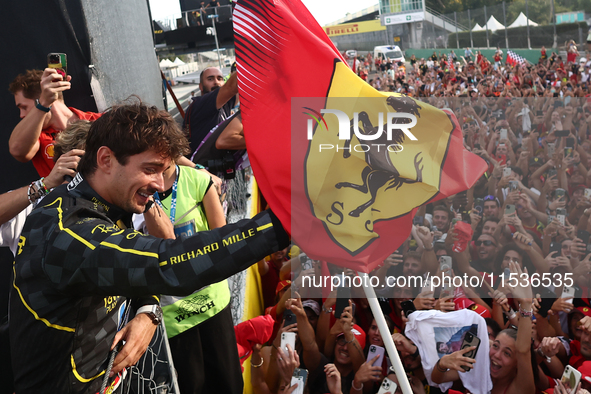 Charles Leclerc of Ferrari celebrates with fans after the Formula 1 Italian Grand Prix at Autodromo Nazionale di Monza in Monza, Italy on Se...