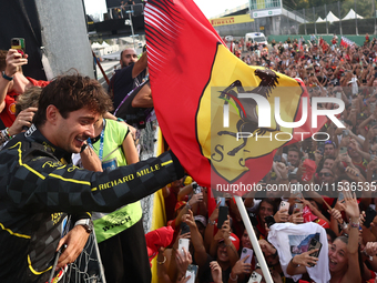 Charles Leclerc of Ferrari celebrates with fans after the Formula 1 Italian Grand Prix at Autodromo Nazionale di Monza in Monza, Italy on Se...