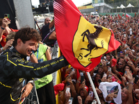 Charles Leclerc of Ferrari celebrates with fans after the Formula 1 Italian Grand Prix at Autodromo Nazionale di Monza in Monza, Italy on Se...