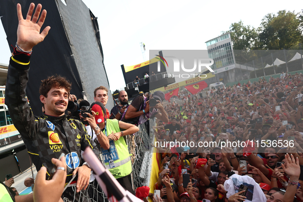 Charles Leclerc of Ferrari celebrates with fans after the Formula 1 Italian Grand Prix at Autodromo Nazionale di Monza in Monza, Italy on Se...