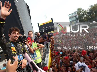 Charles Leclerc of Ferrari celebrates with fans after the Formula 1 Italian Grand Prix at Autodromo Nazionale di Monza in Monza, Italy on Se...