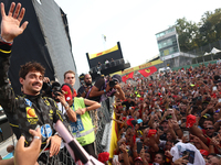 Charles Leclerc of Ferrari celebrates with fans after the Formula 1 Italian Grand Prix at Autodromo Nazionale di Monza in Monza, Italy on Se...