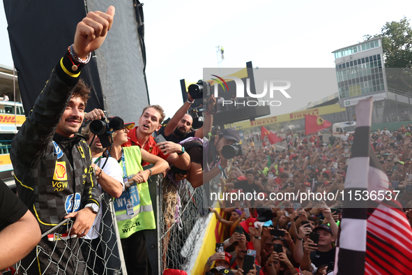 Charles Leclerc of Ferrari celebrates with fans after the Formula 1 Italian Grand Prix at Autodromo Nazionale di Monza in Monza, Italy on Se...