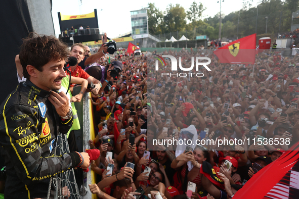 Charles Leclerc of Ferrari celebrates with fans after the Formula 1 Italian Grand Prix at Autodromo Nazionale di Monza in Monza, Italy on Se...