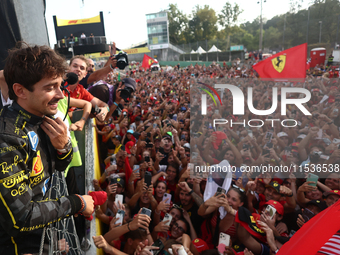 Charles Leclerc of Ferrari celebrates with fans after the Formula 1 Italian Grand Prix at Autodromo Nazionale di Monza in Monza, Italy on Se...