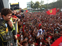 Charles Leclerc of Ferrari celebrates with fans after the Formula 1 Italian Grand Prix at Autodromo Nazionale di Monza in Monza, Italy on Se...