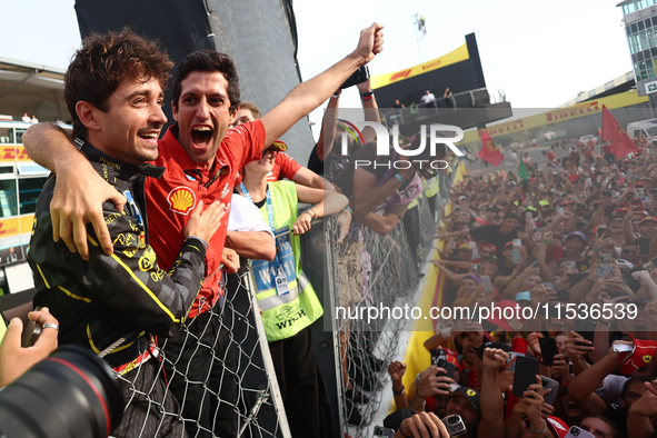 Charles Leclerc of Ferrari celebrates with fans after the Formula 1 Italian Grand Prix at Autodromo Nazionale di Monza in Monza, Italy on Se...