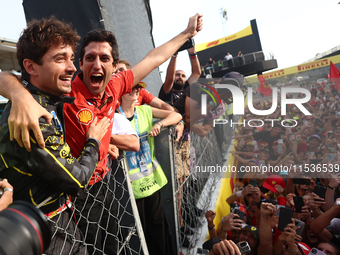 Charles Leclerc of Ferrari celebrates with fans after the Formula 1 Italian Grand Prix at Autodromo Nazionale di Monza in Monza, Italy on Se...