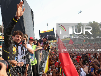 Charles Leclerc of Ferrari celebrates with fans after the Formula 1 Italian Grand Prix at Autodromo Nazionale di Monza in Monza, Italy on Se...