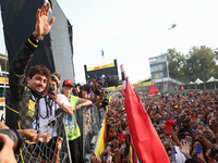 Charles Leclerc of Ferrari celebrates with fans after the Formula 1 Italian Grand Prix at Autodromo Nazionale di Monza in Monza, Italy on Se...