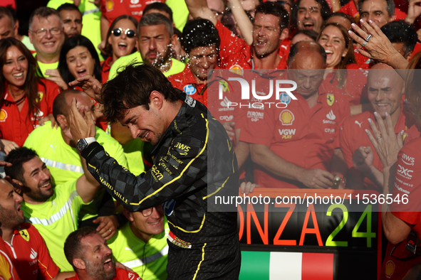 Charles Leclerc of Ferrari celebrates with the team after the Formula 1 Italian Grand Prix at Autodromo Nazionale di Monza in Monza, Italy o...