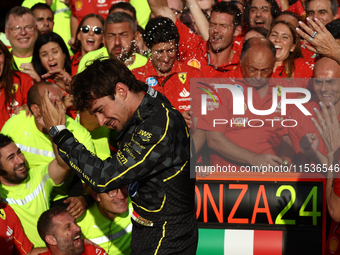 Charles Leclerc of Ferrari celebrates with the team after the Formula 1 Italian Grand Prix at Autodromo Nazionale di Monza in Monza, Italy o...