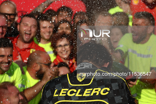 Charles Leclerc of Ferrari celebrates with the team after the Formula 1 Italian Grand Prix at Autodromo Nazionale di Monza in Monza, Italy o...