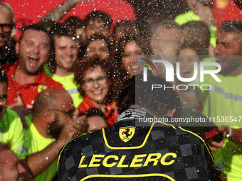 Charles Leclerc of Ferrari celebrates with the team after the Formula 1 Italian Grand Prix at Autodromo Nazionale di Monza in Monza, Italy o...