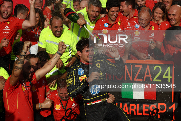 Charles Leclerc of Ferrari celebrates with the team after the Formula 1 Italian Grand Prix at Autodromo Nazionale di Monza in Monza, Italy o...