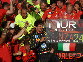 Charles Leclerc of Ferrari celebrates with the team after the Formula 1 Italian Grand Prix at Autodromo Nazionale di Monza in Monza, Italy o...